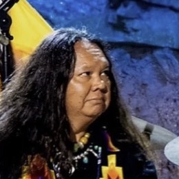 Native American culture bearer performing