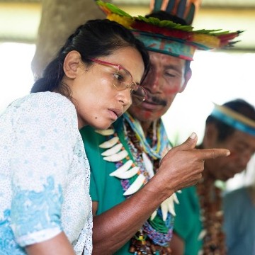 Siona community members gathered around a map